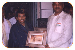 Mr. N Bitra Receiving A memento from Pinnamaneni Venkateswara Rao, Minister Technical Education, on the occasion of 56th Independence Day (15th August 2003). Bitra Net Pvt. Ltd., has donated two letest configuration computers to a School located in Puttagunta (Krishna Dist, Andhra Pradesh)